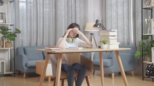 Tired Teenager Having Headache While Learning At Home