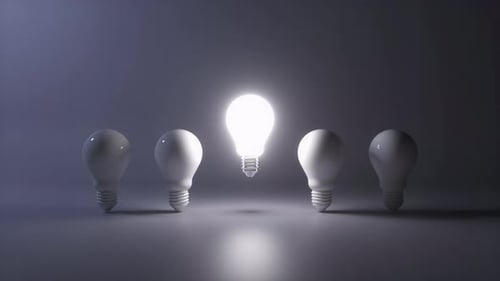One light bulb standing out from others bulbs floating on dark background.