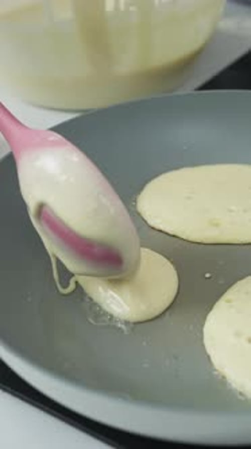 Vertical Of Pouring Pancake Batter Into Pan. Close-up Shot