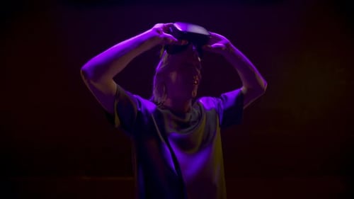 Man Wearing VR Headset in a Dark Room
