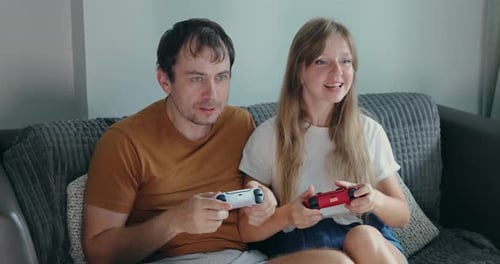 Happy Couple Play Video Game At Home