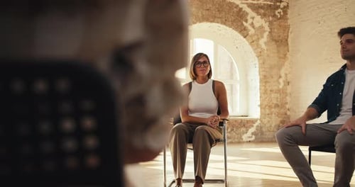 Participants in Group Therapy Sit in a Circle Chat and Applaud Each Other The Camera Rotates in a