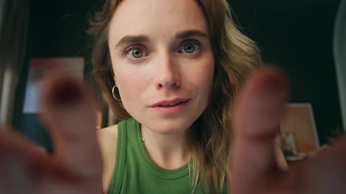 Amazed Lady Zooming Fingers Screen at Home Web Camera View. Surprised Woman