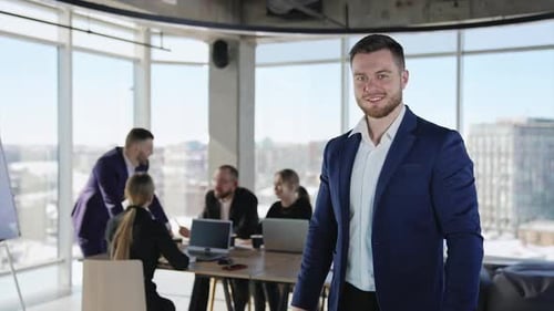 Smiling Businessman in Modern City Office
