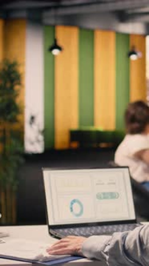 Vertical Video Corporate Lifestyle Scene with Man Reviewing KPI Metrics and Data Analysis