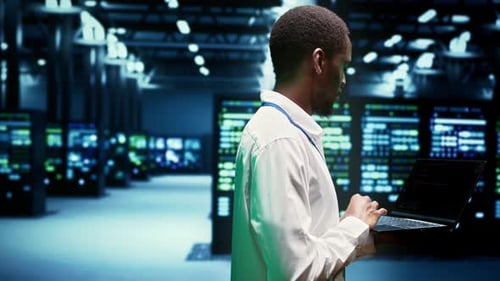 Data Center Engineer Working on Laptop