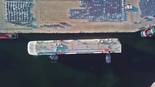 Drone view of container ship docking at the port