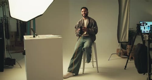 Face, man and photographer on camera in studio of photoshoot, about us and catalog