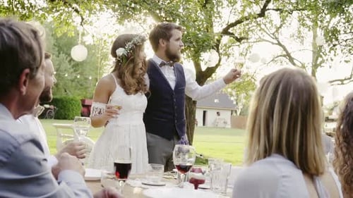 Newlyweds Giving Speech at Outdoor Wedding Reception