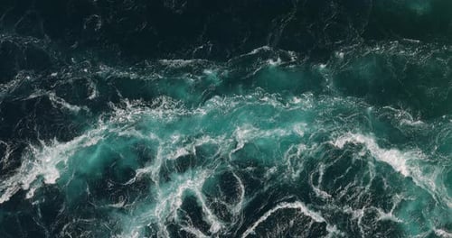 Blue waves of water of the river and the sea meet each other during high tide and low tide.