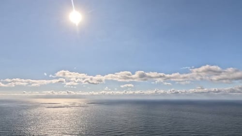 Timelapse Fluffy Cumulus Clouds Moving in Bright Golden Sunset Sky Over Sea Abstract Aerial Nature