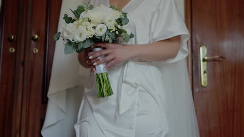Bride Holding Beautiful Bouquet Before the Wedding