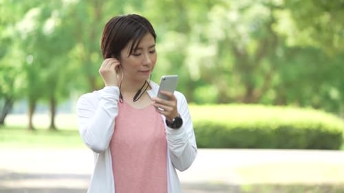 Woman Exercising With Phone and Smart Watch