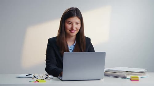 Young Woman Celebrates Success in Office