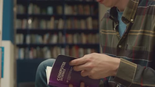 Student Choosing and Reading Textbook on Computer Science in Library