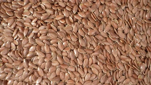 Abundance of Brown Flax Seeds Close Up