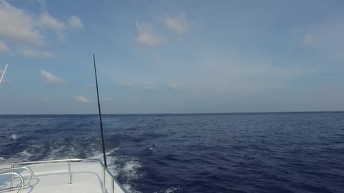 Boat sailing on the open ocean on sunny day