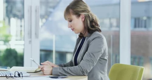 4k video of a young businesswoman working on a digital tablet in an office