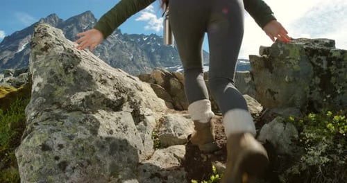 Woman Hiking Mountain Trail to Scenic Peak