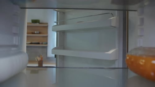 View From Inside of Refrigerator Guy Standing Near Opening Fridge Closeup Footage of AfroAmerican