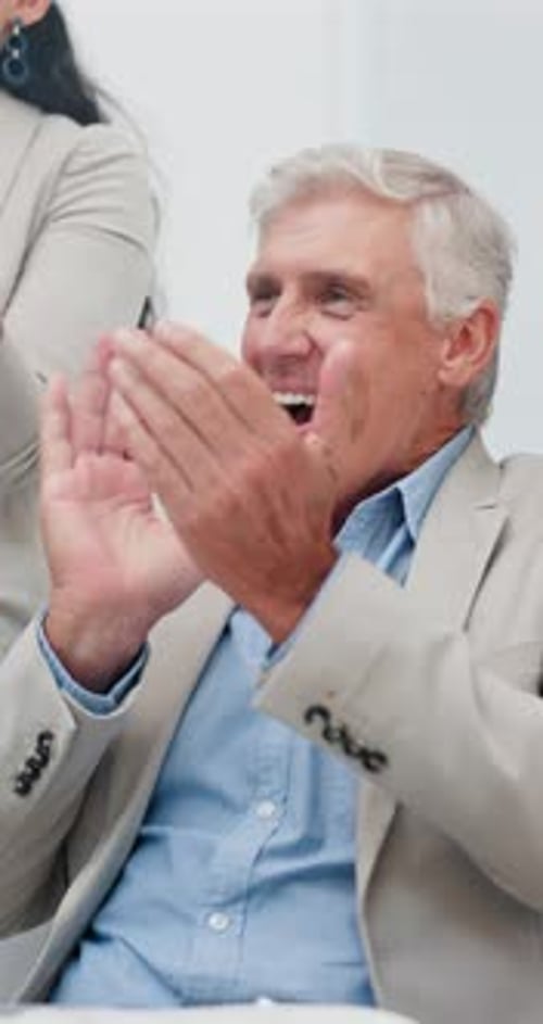 Corporate Team Applauds in a Modern Office