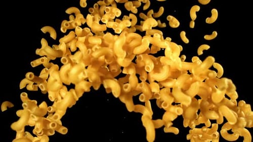 Elbow Macaroni Spiraling Upward on Black Background