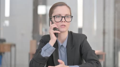 Business Woman Talking on Phone in Office