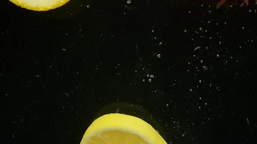 Citrus Fruit Slices Plunging Into Water