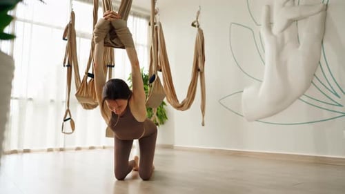 Woman Doing Aerial Yoga in Studio