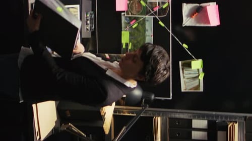 Woman Reviews Case File at Crime Scene