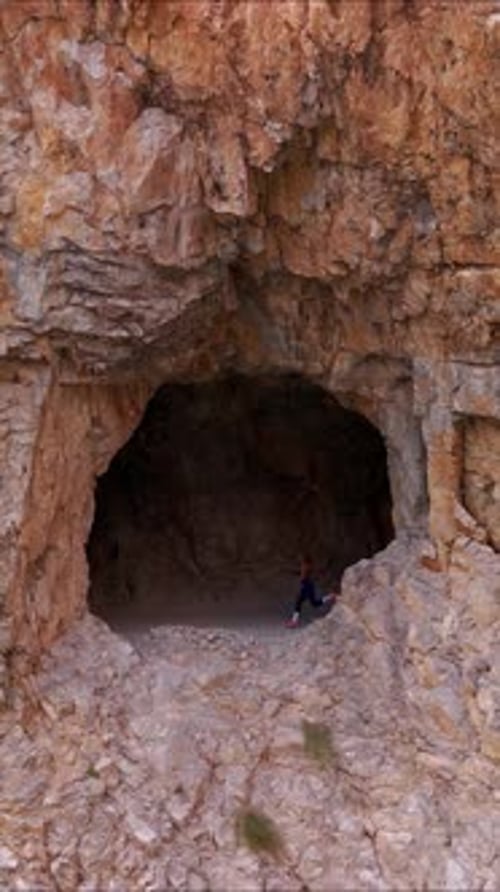 Female Athlete in Rocky Cave