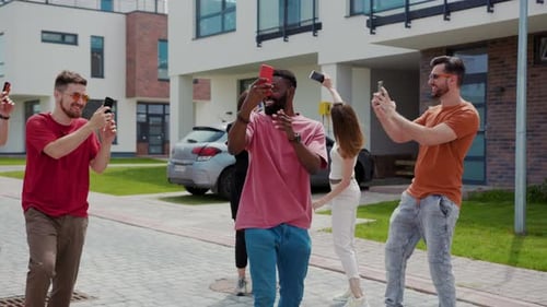 Happy Friends Taking Pictures on the Street Together