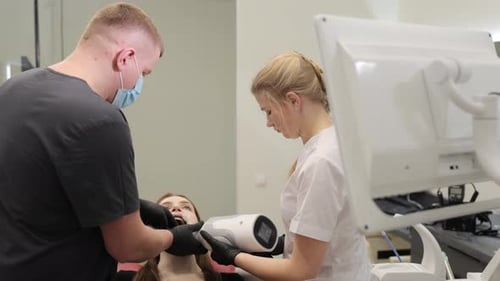Dentist Scanning Patient's Teeth with Handheld Device