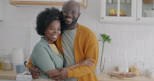 Affectionate Couple Embracing in Bright Kitchen