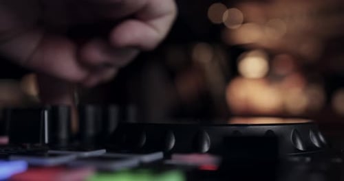 Hand Adjusts Knobs on Black Sound Mixer