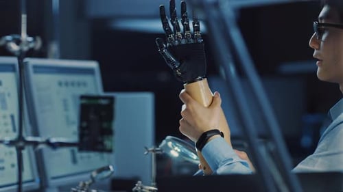 Futuristic Prosthetic Robot Arm Being Tested by a Professional Japanese Development Engineer in a H