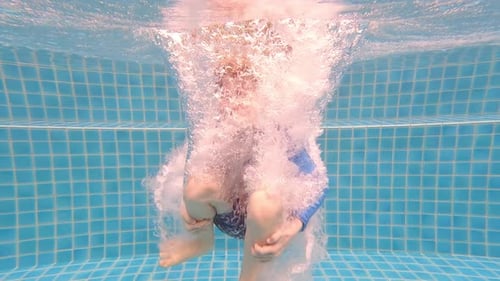 Boy Submerging And Floating Underwater