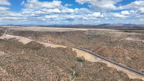 Aerial view of desert landscape with mountains and road, United States.