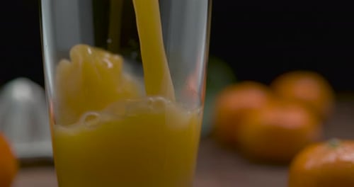 Fresh Orange Juice Being Poured Into a Glass