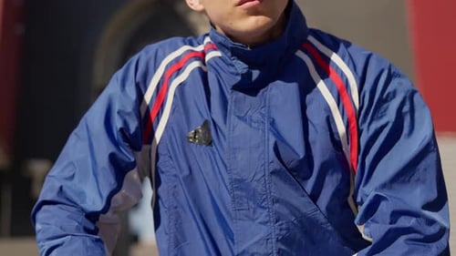 Young Man In Tracksuit Dancing In Street