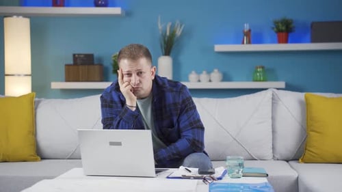 Home office worker man thinking looking at camera.