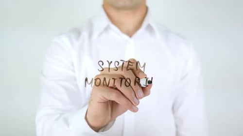 Man Writes 'System Monitoring' on Clear Surface