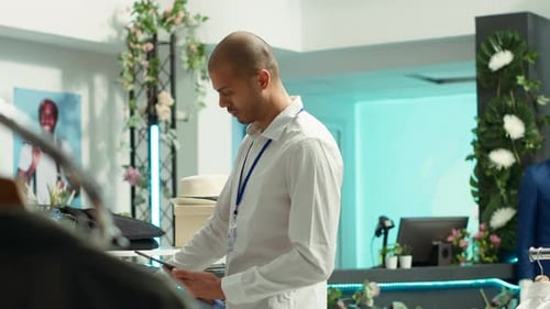 Young Adult Browsing Clothes in a Fashion Store