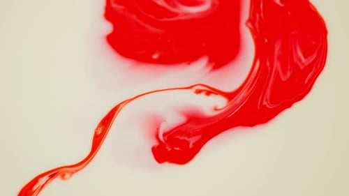 Abstract Red Fluid Mixing with White Fluid