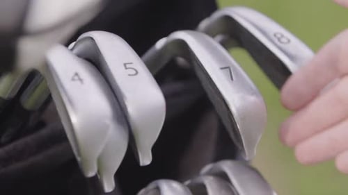 Pulling 7 Iron Golf Club out of golf bag in slow motion