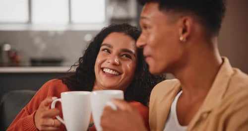Smiling Couple Relaxing at Home with Coffee