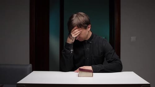 Young Adult with Religious Book and Rosary