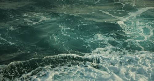 Clear ocean water with powerful stormy sea waves. Top down of pure foamy texture. Earth element.