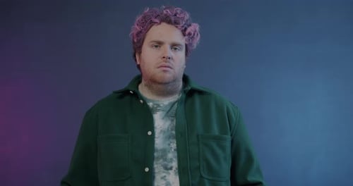 Man with Wavy Pink Hair Opens and Closes Eyes