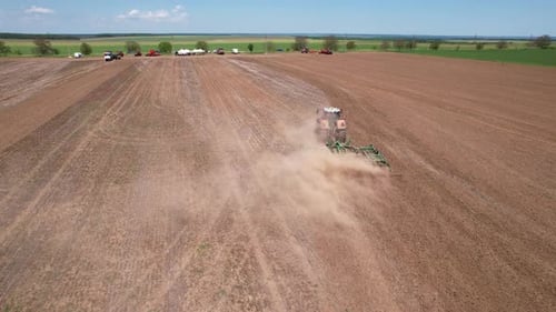 Aerial view of tractor plowing field, Bulgaria.
